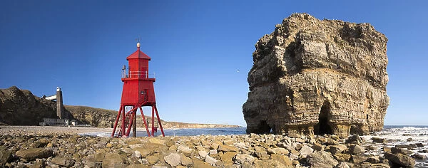Groyne Lighthouse Beside A Rock Formation Along The Shoreline; South Shields, Tyne And Wear, England