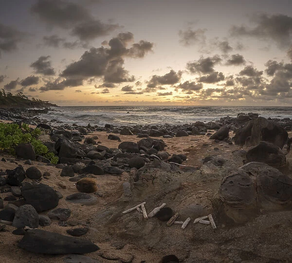 Lava rocks on the sandy beach along the Kauai Multiuse Trail at twilight, Kauai, Hawaii, USA