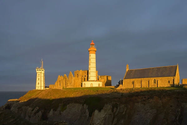 Lighthouse in the morning, Saint Mathieu lighthouse with ruin of Benedictine abbey, Pointe Saint-Mathieu, Plougonvelin, Finistere, Brittany, France