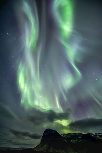 northern lights dance over a mountain range on Icelands South Coast, Vik, Iceland