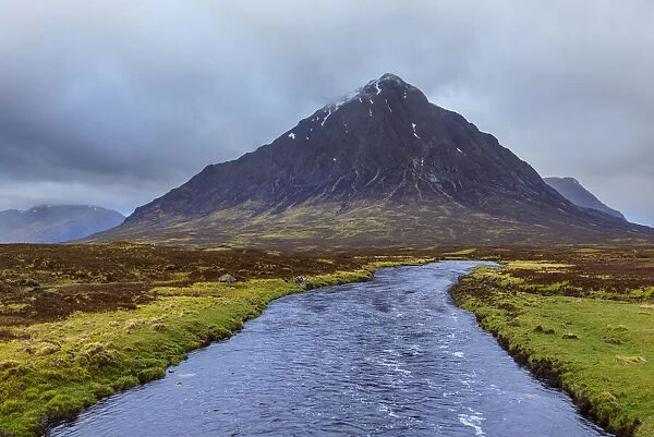 River Etive and mountain range Buachaille Etive Mo with cloudy sky at Glen Coe in Scotland, United Kingdom