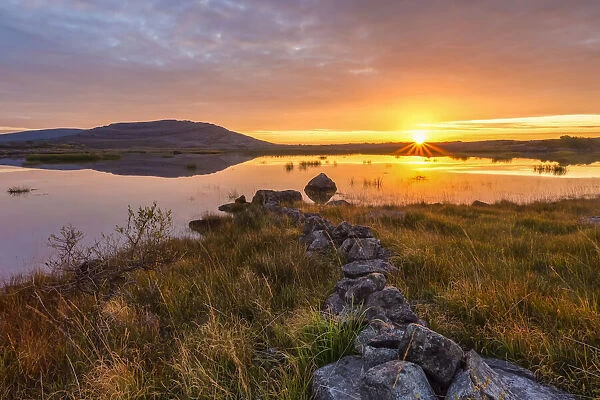 Sunrise over a lake, Burren National Park, Clare, Ireland