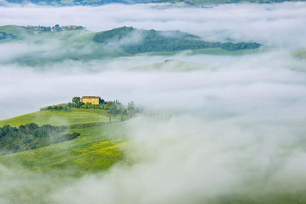 Typical Tuscany landscape with farm in morning with fog near Pienza. Pienza, Siena district, Tuscany, Toscana, Italy