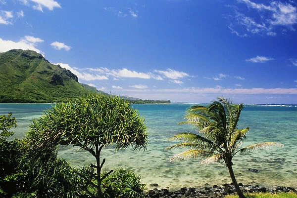 USA, Hawaii, Oahu, Crystal Clear Water And Lush Green Mountains In Distance; Kahana Bay, Bright Blue Sky