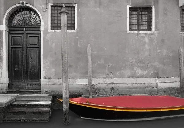 Venice, Italy; A Small Boat With A Red Cover On A Canal