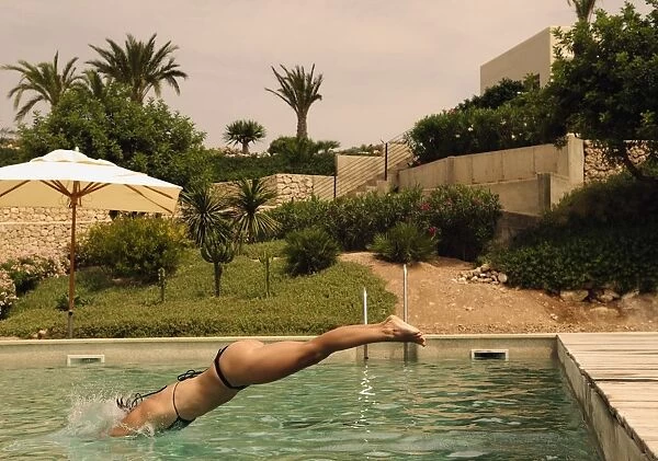 Woman Diving Into Swimming Pool