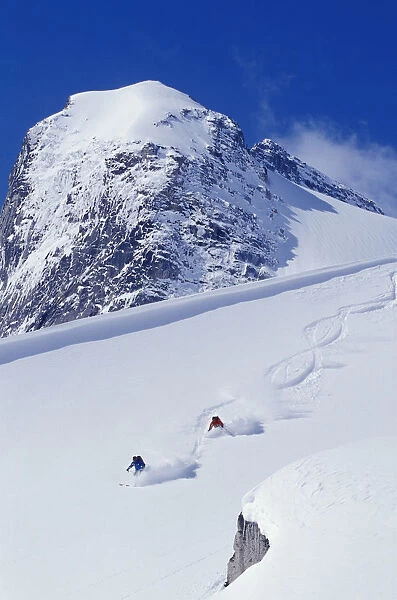 Two Young Men Skiing Untracked Powder In Figure 8 s, Bugaboo Glacier Provincial Park, British Columbia, Canada