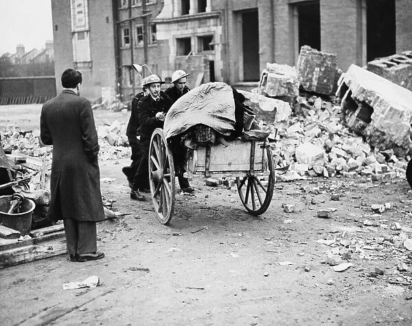 A. R. P. workers taking away childrens belongings from a bombed school in Sandhurst