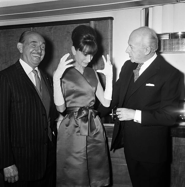 Actress Audrey Hepburn pictured with Jack L Warner (left
