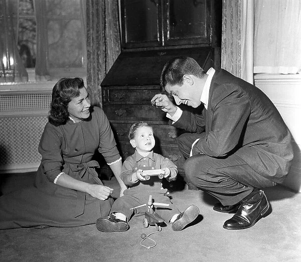 American Comedian and actor Jerry Lewis at home with his wife playing with their son