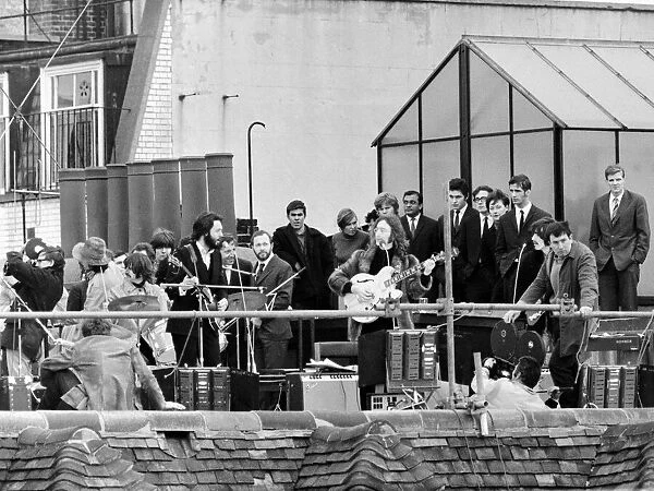 Beatles on the rooftop of their Apple headquarters in London Saville Row giving their
