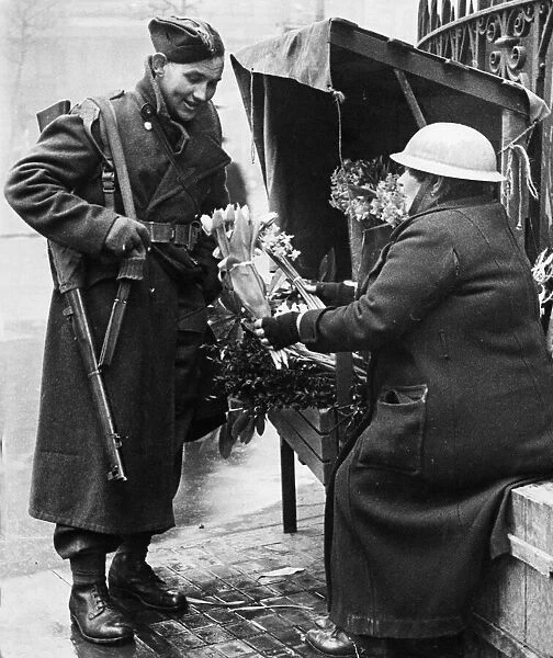 A British soldier buying flowers for his wife in central London as he returns home