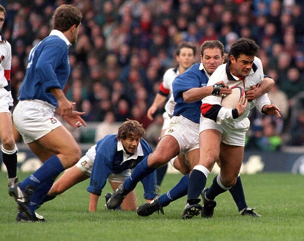 Will Carling is tackled as he tries to break the Italian defence during the England v