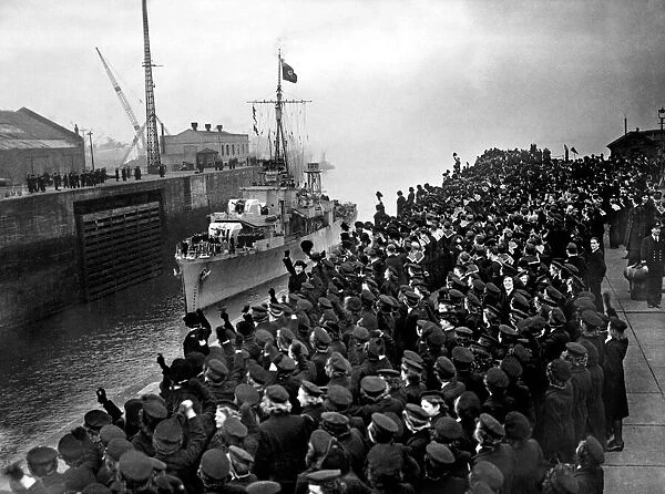Cheering sailors and Wrens of the Royal Navy line the entrance to Gladstone dock in