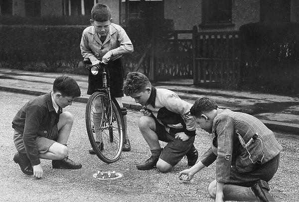 Children playing marbles game in the street, Scotland. 1947