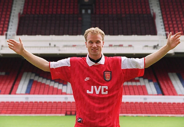 Dennis Bergkamp demonstrates the size of his fee after signing for Arsenal for £7