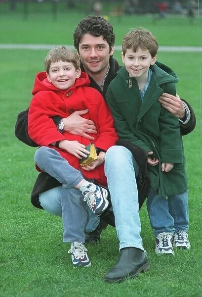 Dominic Taylor actor with his sons Arthur 6 in red coat and Jack 7 in green coat