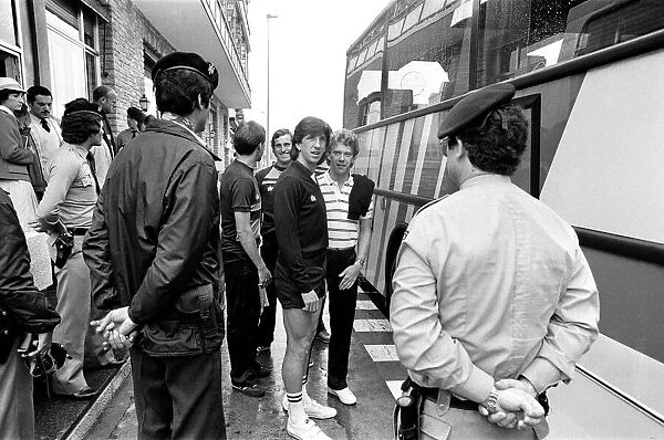 England footballers Paul Mariner and Graham Rix wait to board the bus at the team hotel