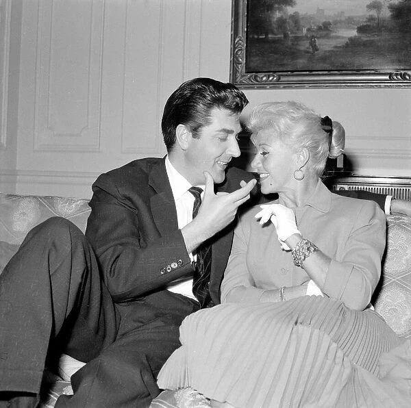 Film actress Ginger Rogers with David Hughes sitting on a couch together May