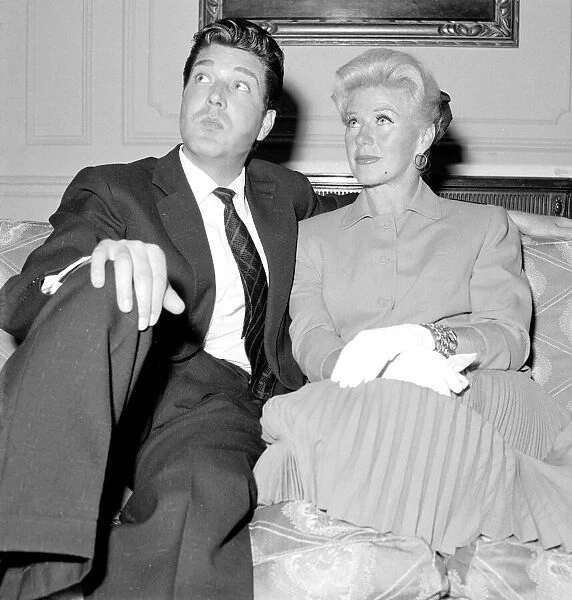 Ginger Rogers with David Hughes sitting on a couch May 1959
