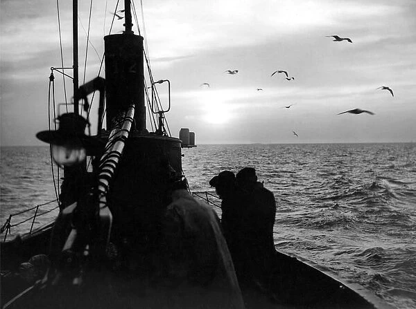 A herring drifter heading for home as the sun comes up and gulls wheel overhead in 1949