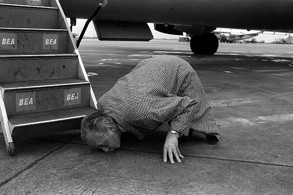 Hughie Green April 1963 Comedian TV Presenter kissing the ground at London Airport