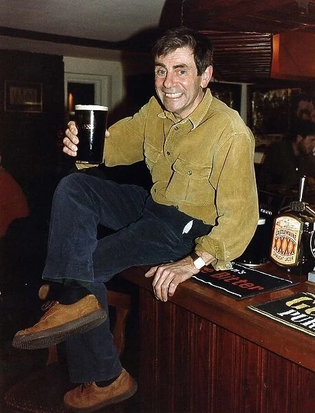 Melvyn Hayes Actor Publican in his Pub in St Albans Hertfordshire Sitting on Bar