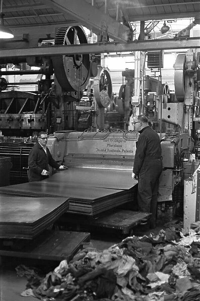 Metal sheets are fed into the body panel press at the The Austin Mini production line