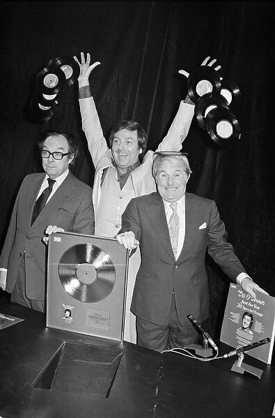 Morecambe and Wise present Des O Connor with a golden disc to mark 100000 sales of
