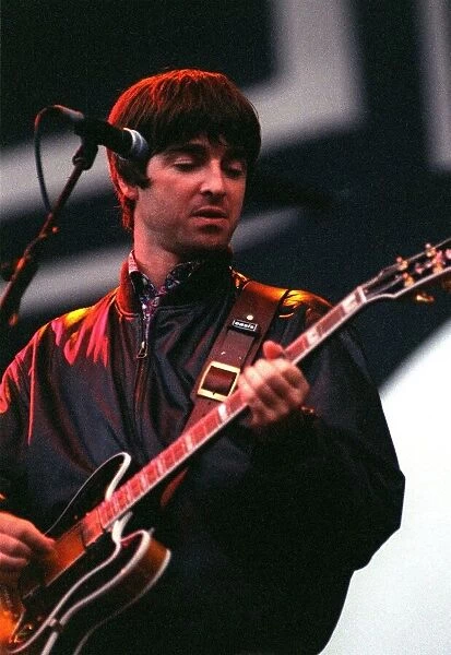 Noel Gallagher of Oasis playing guitar on stage during their concert at Balloch Country