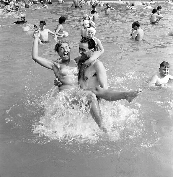 Rhyl bathing pool. Pauline Jones, 23, of Rhyl in the arms of her brother-in-law John