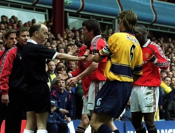 ROY KEANE IS RESTRAINED BY TONY ADAMS AFTER DISALLOWED GOAL FOR OFFSIDE IN THE FA CUP