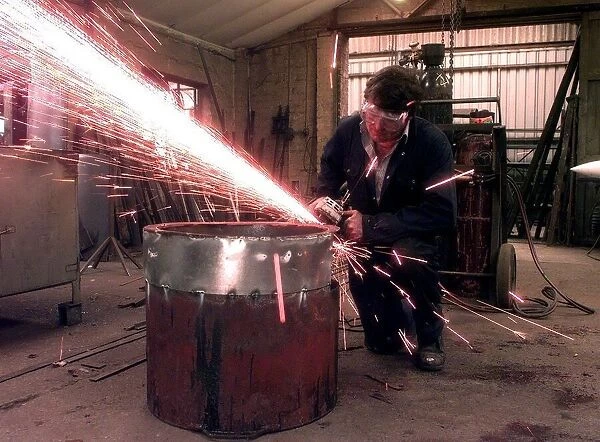 Sparks fly as the blacksmith works at the Forge, in Little Aston, Staffordshire