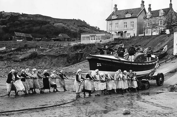 Women of Runswick Bay in Yorkshire, all pulling together on the rope to launch