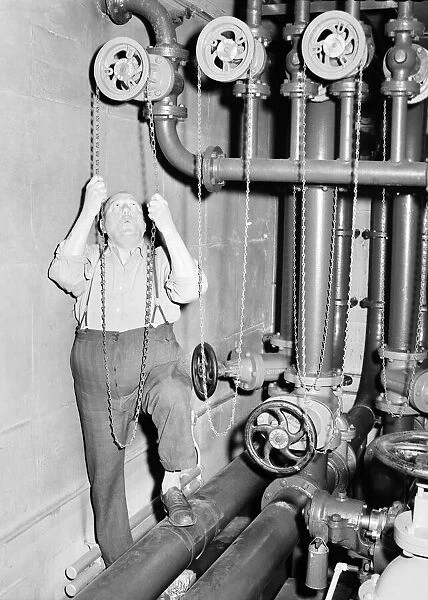 Workman: Man who turns on the pumps for the Trafalgar Square fountains. 1957 A88-004