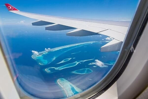 10.12.2016 - Maldives, Male: Turkish Airlines Being 777 landing in Maldives capital city and airport, blue sea and island view from plane