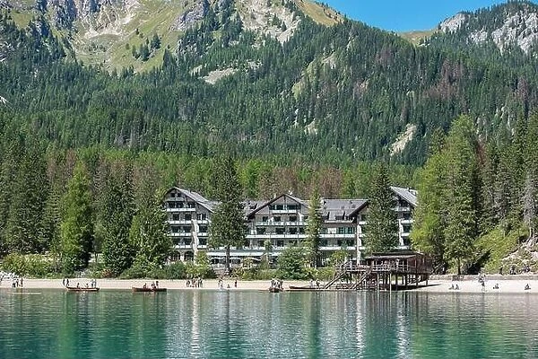 Braies, Italy - 21 August 2022: Hotel on Lake Braies, in the Dolomites Alps, among the green forest and mountains