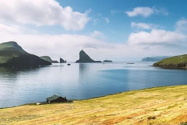 Breathtaking view on Drangarnir and Tindholmur sea stacks in Atlantic ocean, Faroe Islands. Landscape photography
