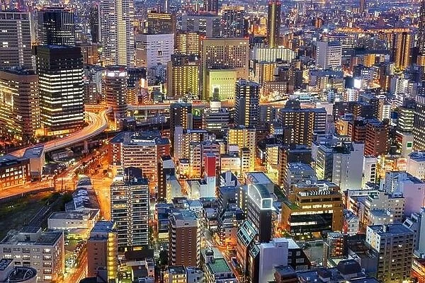 Osaka, Japan cityscape with dense architecture in the Umeda District at night