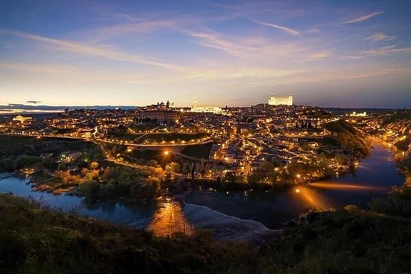 Panoramic view of the medieval center of the city of Toledo, Spain. It features the Tejo river, the Cathedral and Alcazar of Toledo, Spain