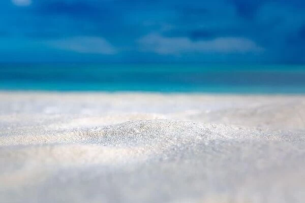 Sandy beach and beautiful tropical sea on blue sky background. Summer sand beach background. Sea and sky. Summer concept
