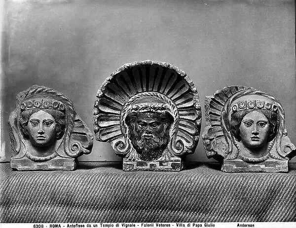 Three antefixes shaped like the head of Silenus and female faces, from the major and minor temples of the ancient Falerii Veteres near the plateau of Vignale, preserved in the Etruscan Museum of Villa Giulia, Rome