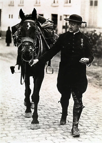A Belgian army chaplain is portrayed while he is going on horseback to the front line of Antwerp
