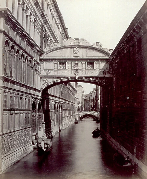 The Bridge of Sighs in Venice. A gondola and a few boats along the rio