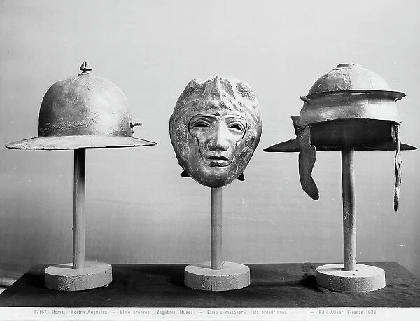 Bronze helmet, helmet and mask with paracheeks. Coming repectively from Zagreb, Stuttgart and Worms, they were at the Augustan Exhibition in Rome in 1938