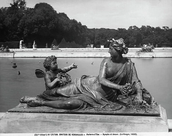 Bronze sculpted group depicting a Nymph and Cupid, work by Charles Le Brun, located in the parterre d'Eau in the park of Versailles