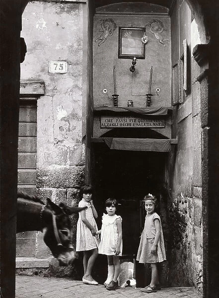 Three girls posing in an alley under a tabernacle