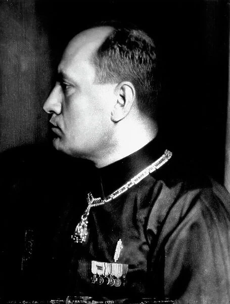 Half-length portrait in profile of Benito Mussolini in black shirt and military decorations