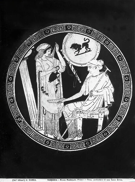 Interior of a red figure Attic kylix, by the painter Douris, depicting Helen pouring liquid into a plate held by king Priam; in the National Museum of Tarquinia, in Tarquinia