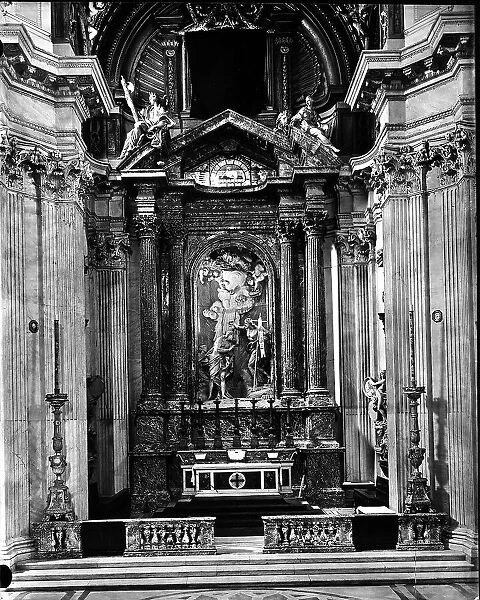 The main altar of the Church of S. Giovanni dei Fiorentini, Rome, work by Borromini, with columns and pilasters in Sicilian jasper. Marble group with the Baptism of Christ by Antonio Raggi